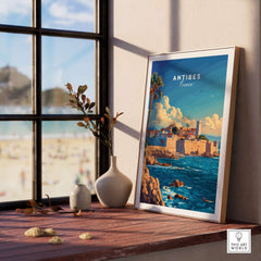 Antibes Wall Art Poster framed on a table by a window, showcasing a scenic view of Antibes, France.