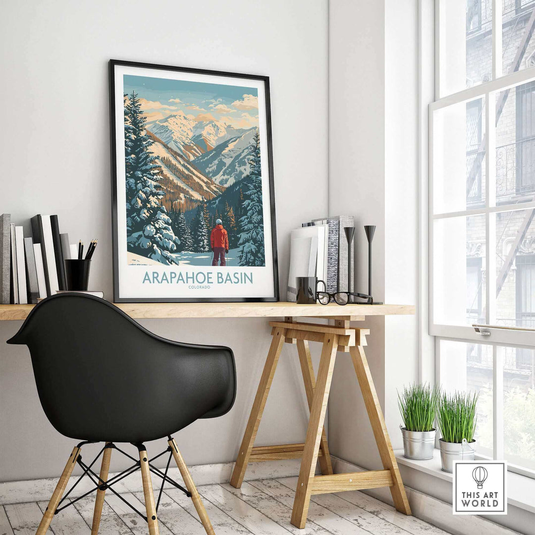 Arapahoe Basin Ski Poster displayed in a modern room with a black chair, showcasing stunning alpine slopes and snowy landscape.