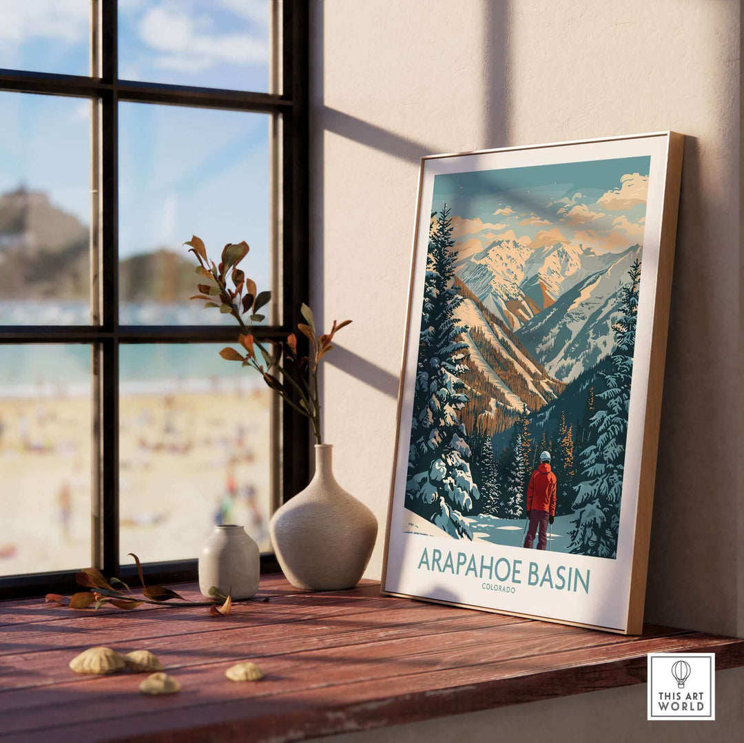 Arapahoe Basin Ski Poster on windowsill with mountain view, enhancing home decor with ski resort imagery. Perfect for winter sports fans.