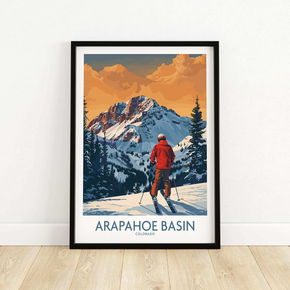 Arapahoe Basin ski print featuring a skier in a red jacket against Colorado's snowy mountains at sunset.