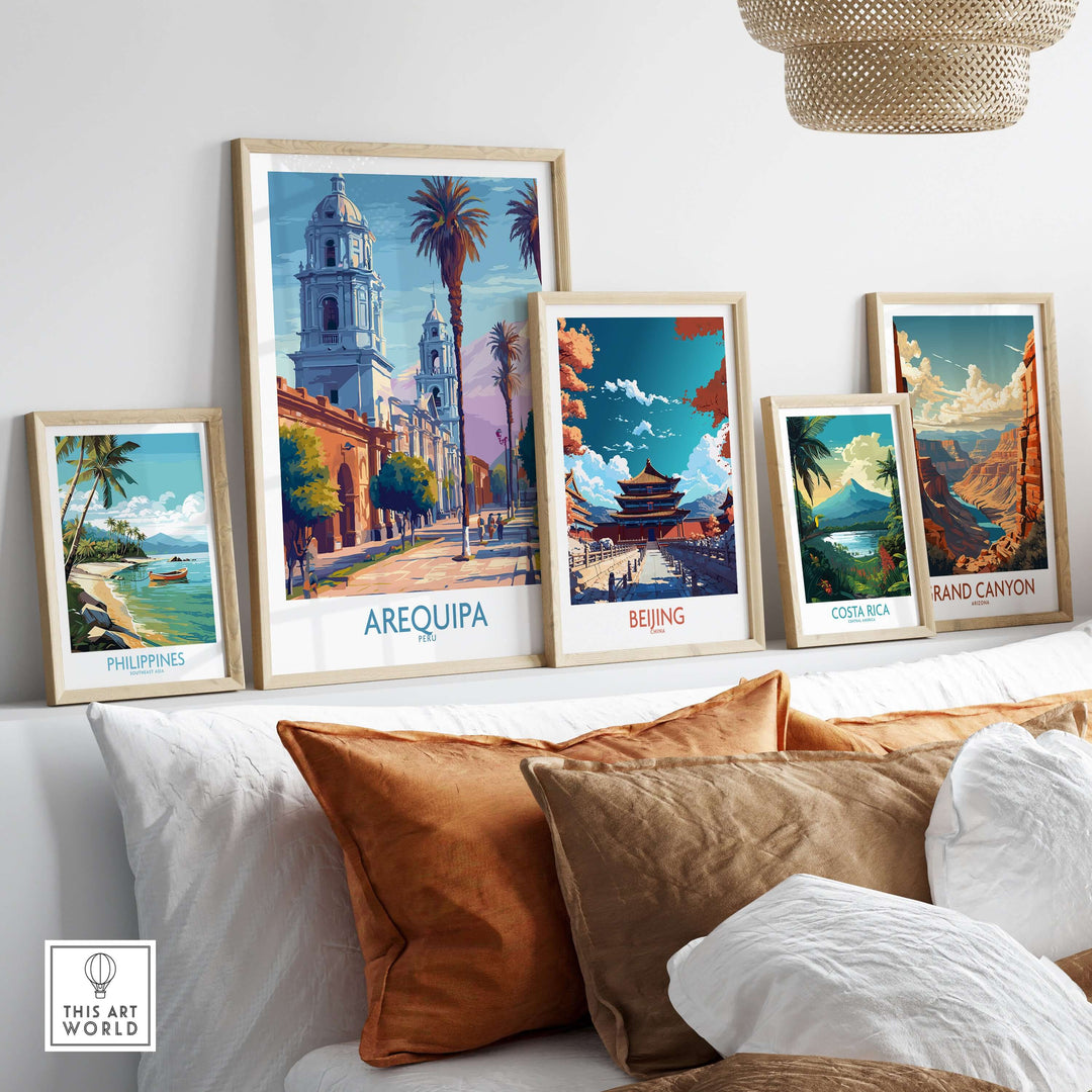 Collection of travel posters including Arequipa, Beijing, and Costa Rica displayed on a wall above a couch.