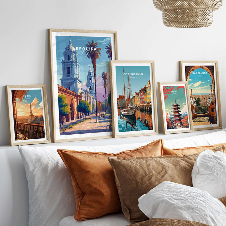 Vibrant Arequipa travel print alongside other framed city wall art on a cozy couch display.