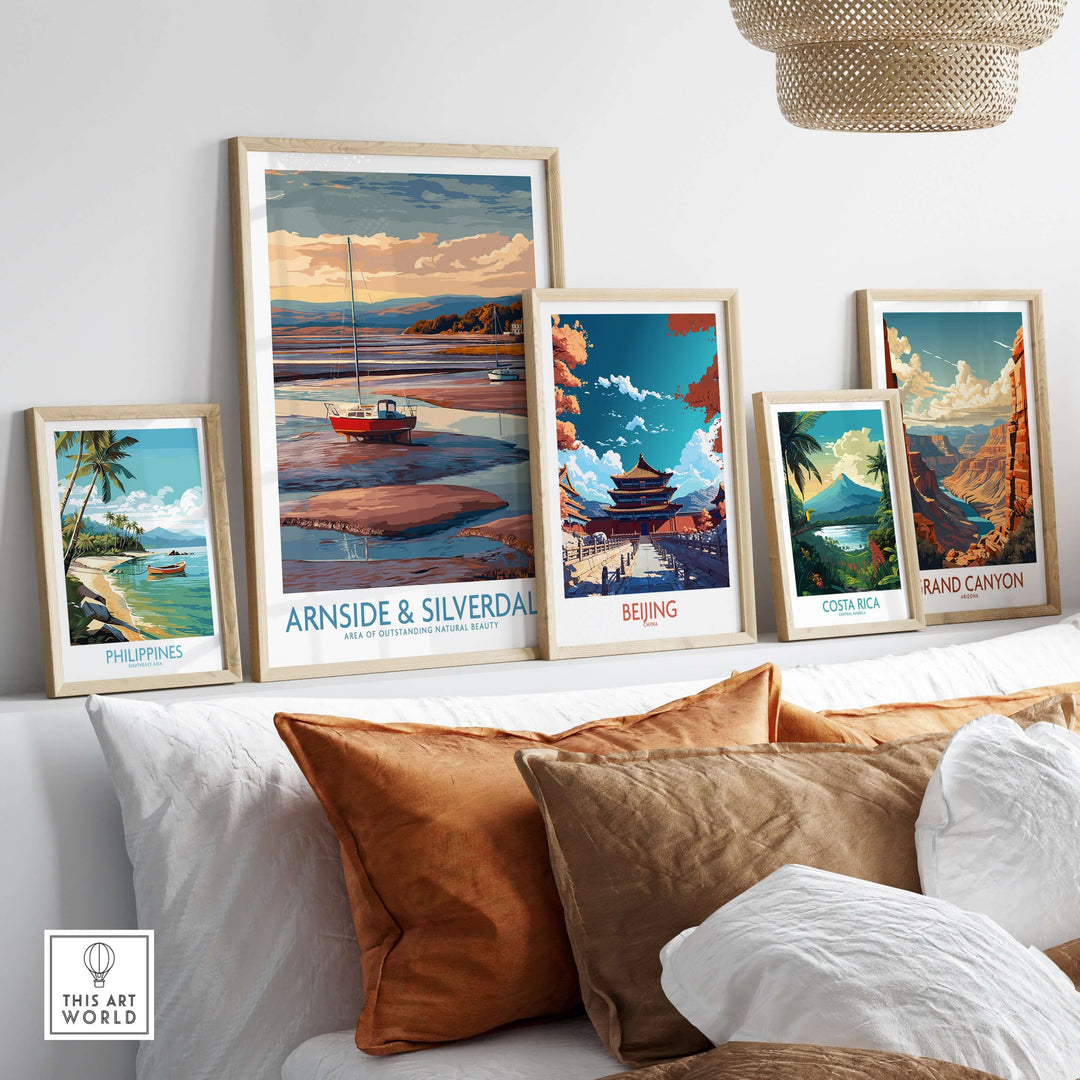 Collection of travel posters including Arnside and Silverdale, Beijing, Costa Rica, and Grand Canyon displayed on a couch.