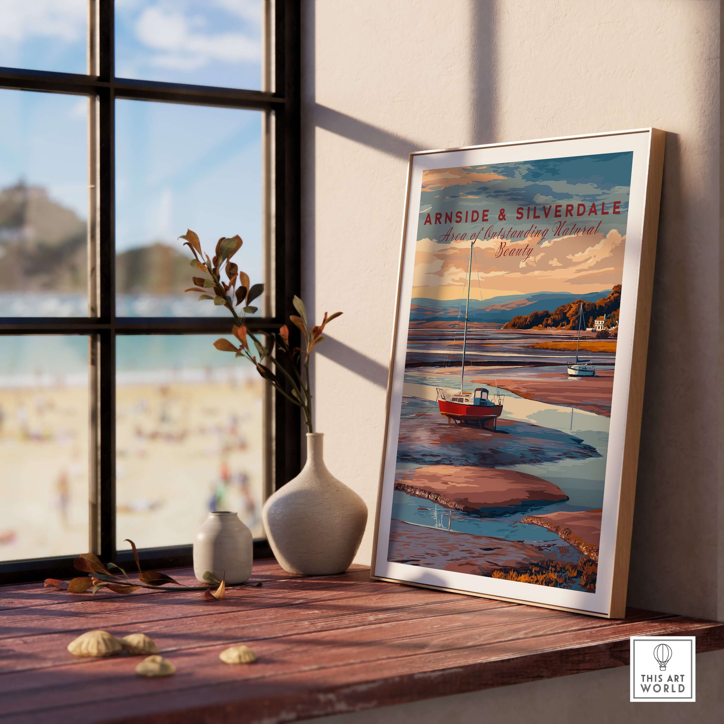 Arnside and Silverdale AONB Travel Print framed on a table near a window, showcasing scenic views and landscapes.