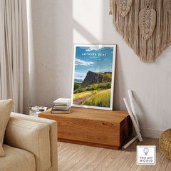 Arthurs Seat Scotland Travel Print displayed in a cozy home interior with natural light and wooden furniture.