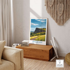 Arthurs Seat Scotland Wall Art Print displayed in a cozy living room setting on a wooden chest.