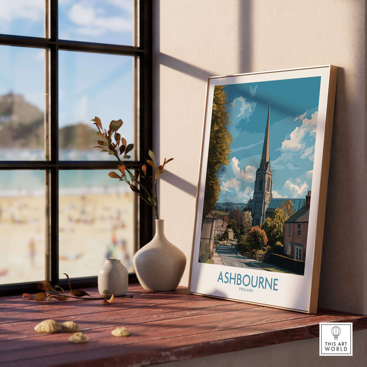 Ashbourne poster showcasing a picturesque UK village scene, displayed elegantly on a windowsill.