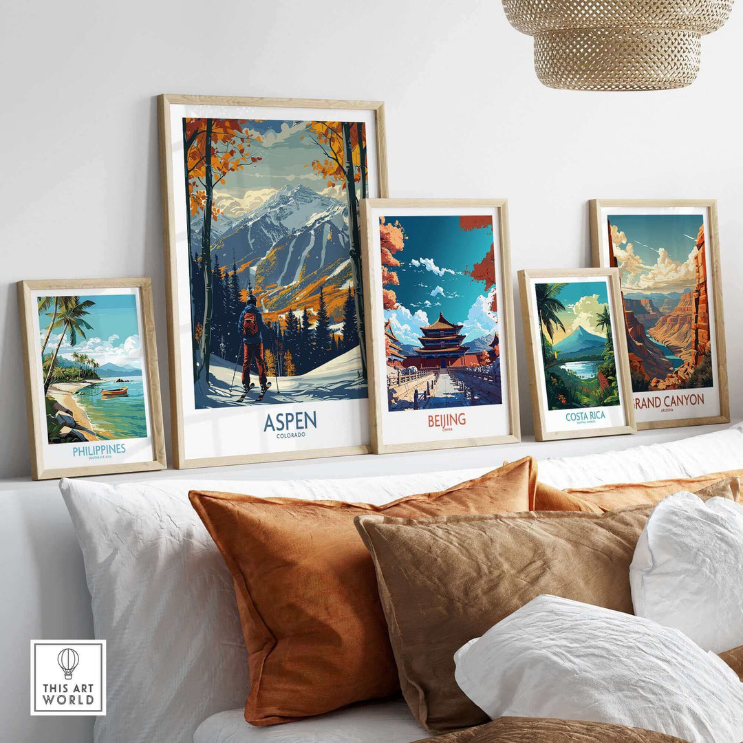 Collection of framed travel posters featuring Aspen ski print alongside images of the Philippines, Beijing, Costa Rica, and Grand Canyon.