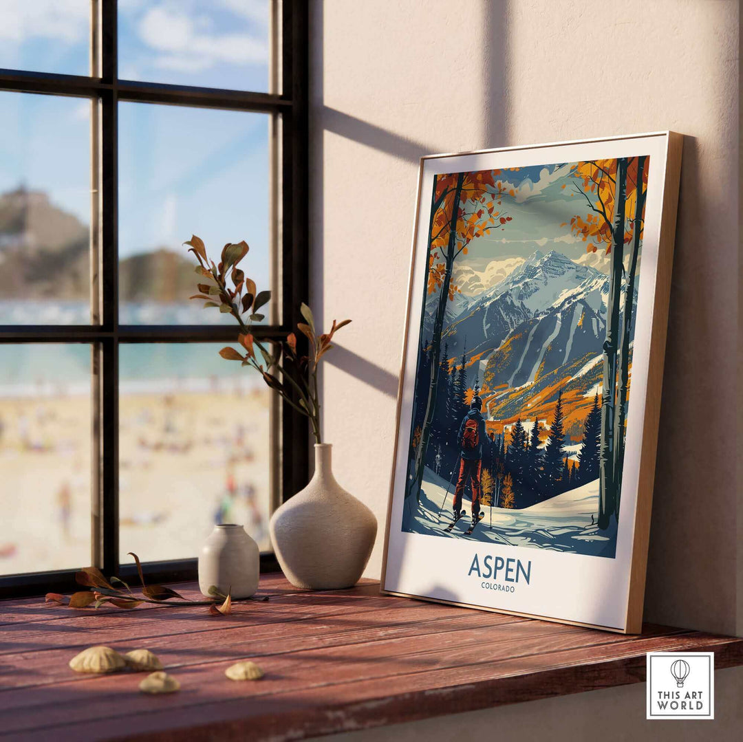 Aspen ski poster print on windowsill, showcasing mountain landscape and vibrant colors, perfect for ski enthusiasts' home decor.