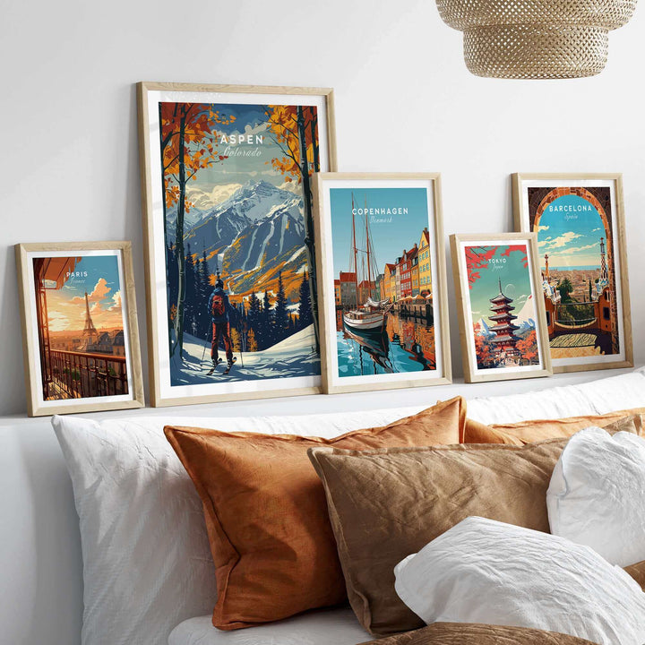 Stylish room with framed Aspen ski poster and travel prints on a shelf above a cozy bed with decorative pillows.