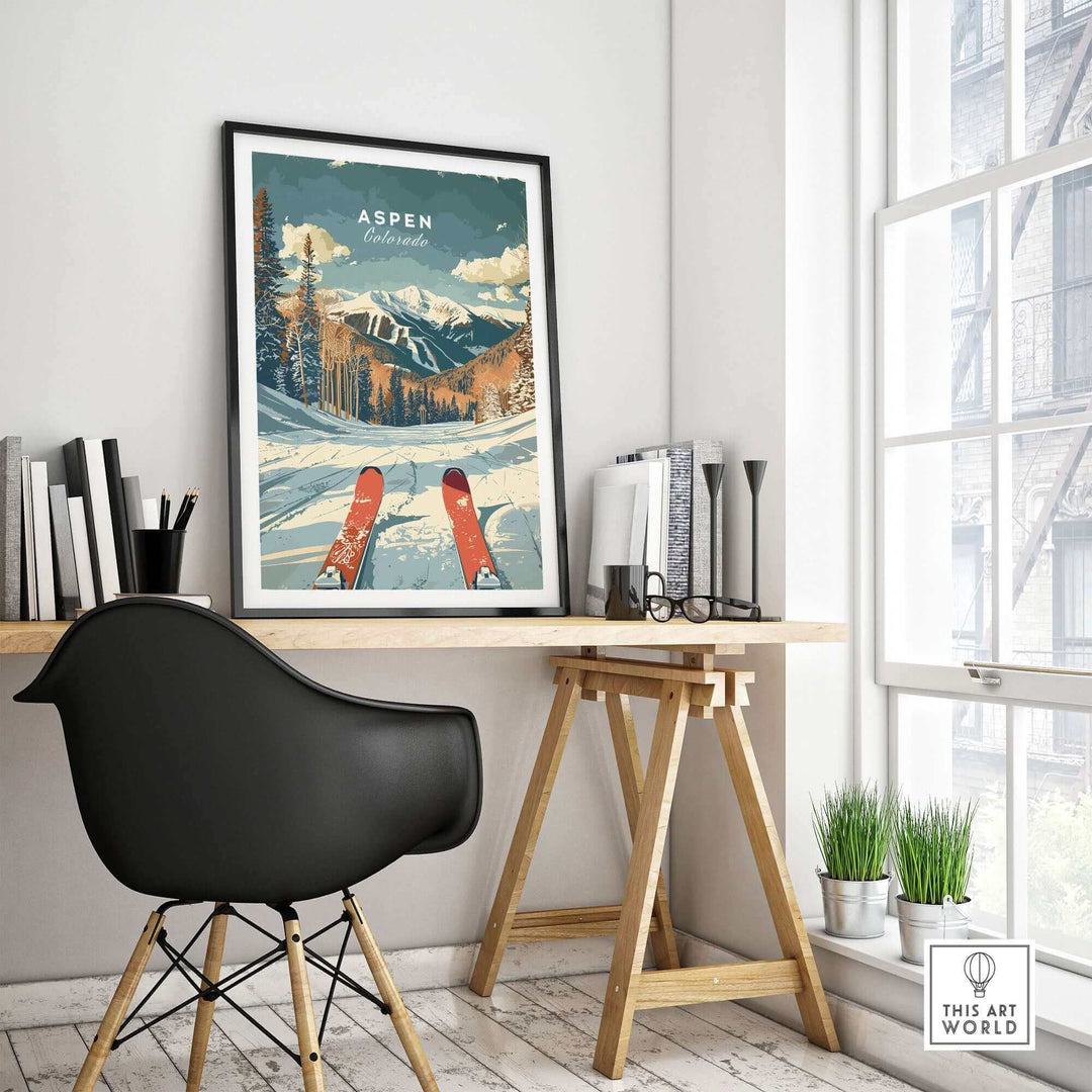 Aspen travel poster displayed in a modern office setting, featuring snow-covered mountains and red skis.