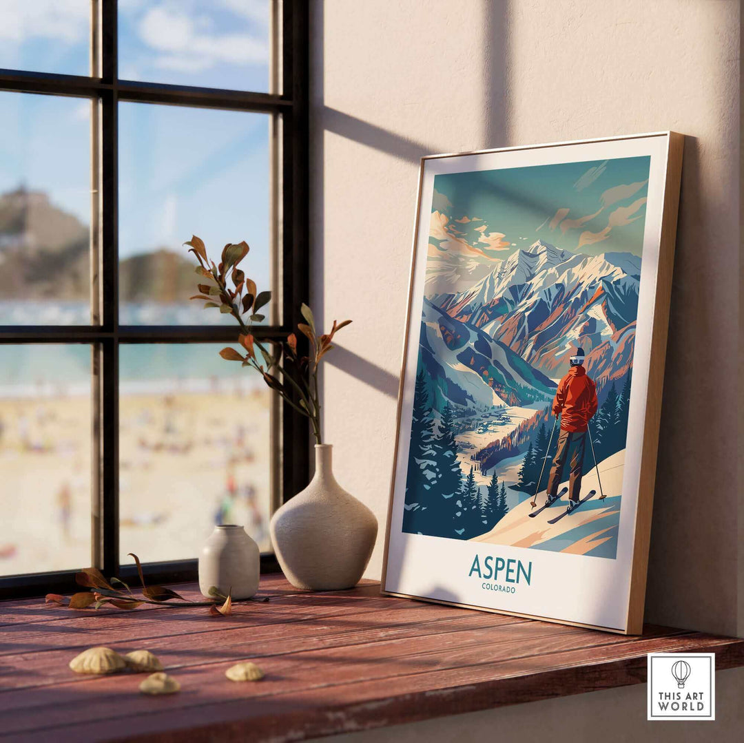 Aspen Wall Art Ski Poster on a windowsill, depicting a vintage mountain scene with a skier, adding rustic charm to home decor.