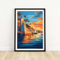 Aswan Travel Print showcasing vibrant sunset over the Nile River, featuring picturesque buildings and sailboats in Aswan, Egypt.