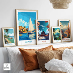 Aswan Wall Art Print displayed among other travel posters on a styled shelf in a modern living room.