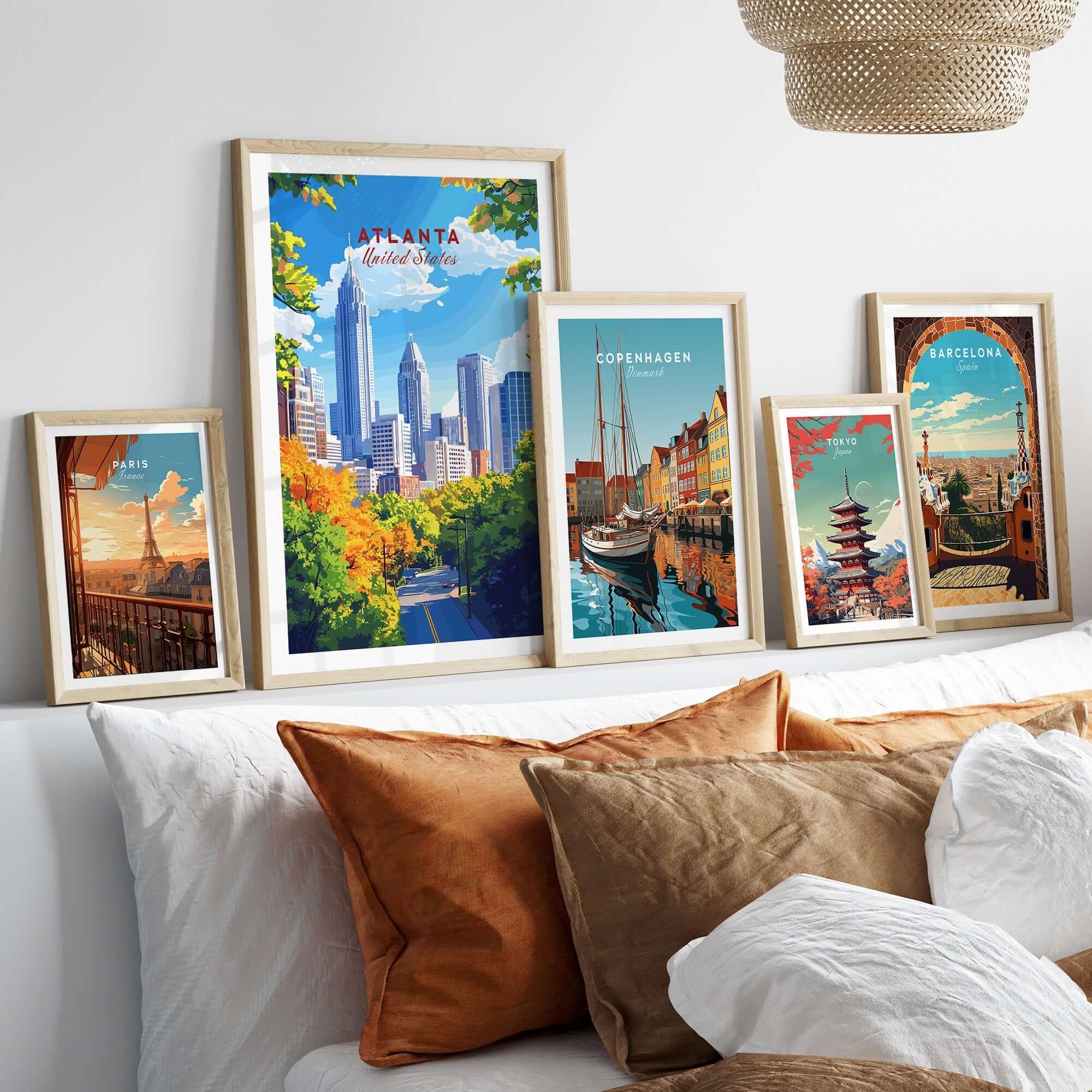 Atlanta Travel Print displayed in stylish frames on a bed, showcasing the vibrant energy of the city.