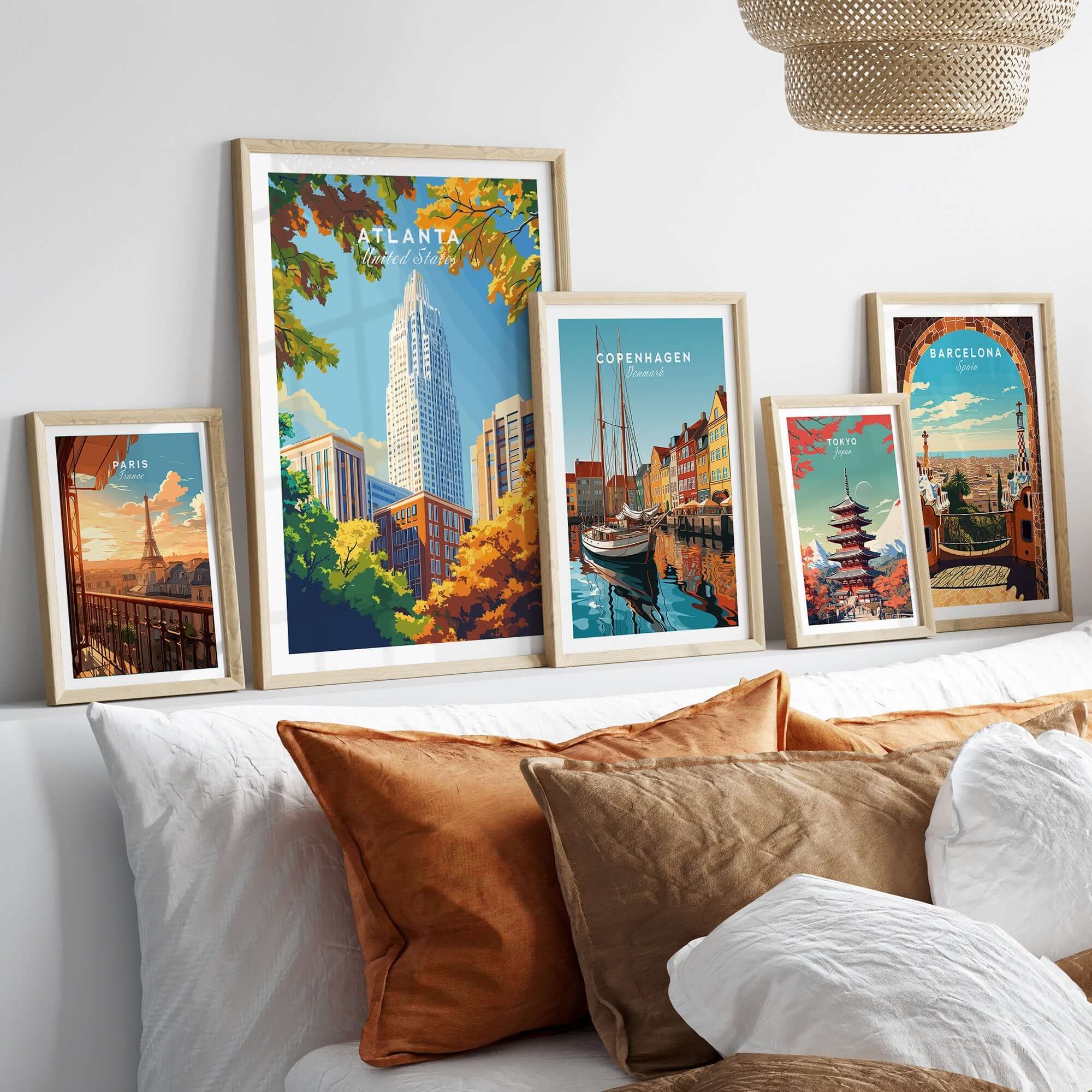 Atlanta Wall Art Poster displayed among framed city posters on a stylish bed with decorative pillows.