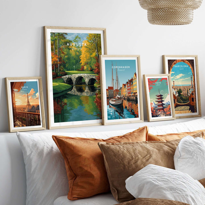 Framed travel prints of Augusta, Copenhagen, Barcelona, and more, displayed elegantly on a cozy couch.