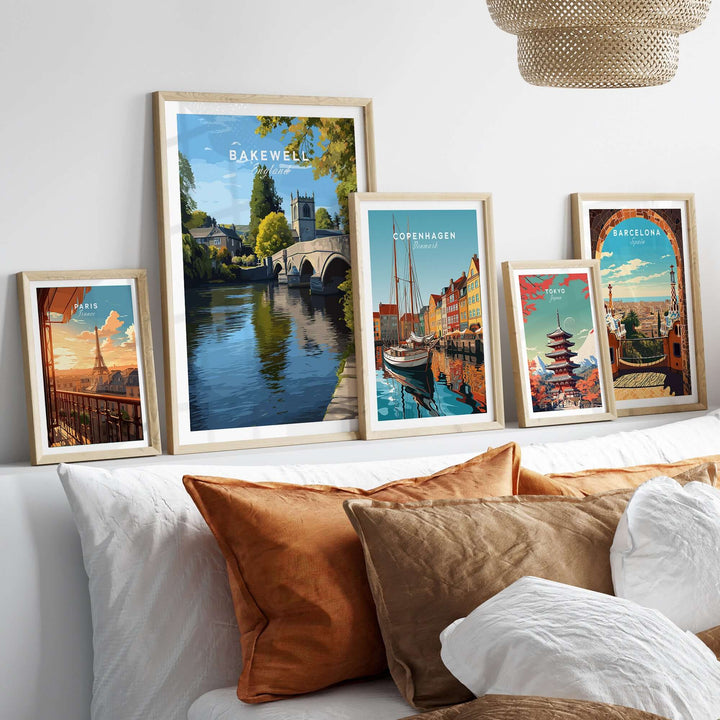 Collection of framed art prints featuring Bakewell, Copenhagen, and Barcelona, displayed on a cozy sofa.