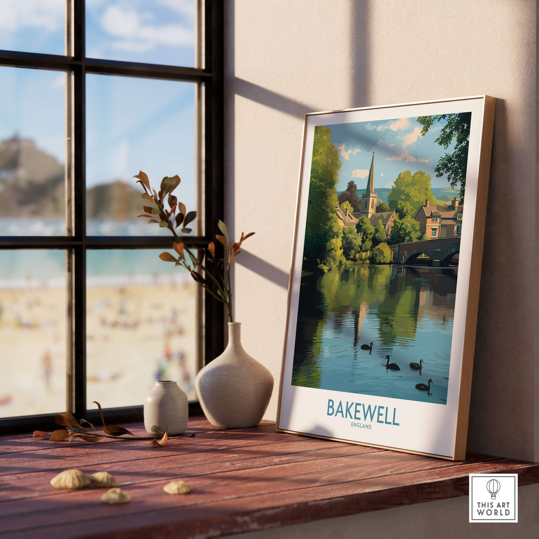 Bakewell poster featuring River Wye scenery, framed art print displayed in a cozy interior by a window.