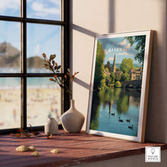 Bakewell Wall Art - River Wye Print - Charming English Village Decor displayed in a sunny window with nature elements.