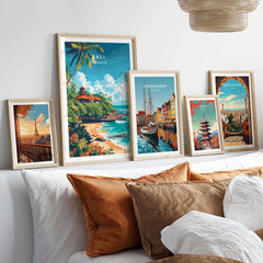 Bali Beach Print and other travel posters displayed on a stylish bed with decorative pillows.