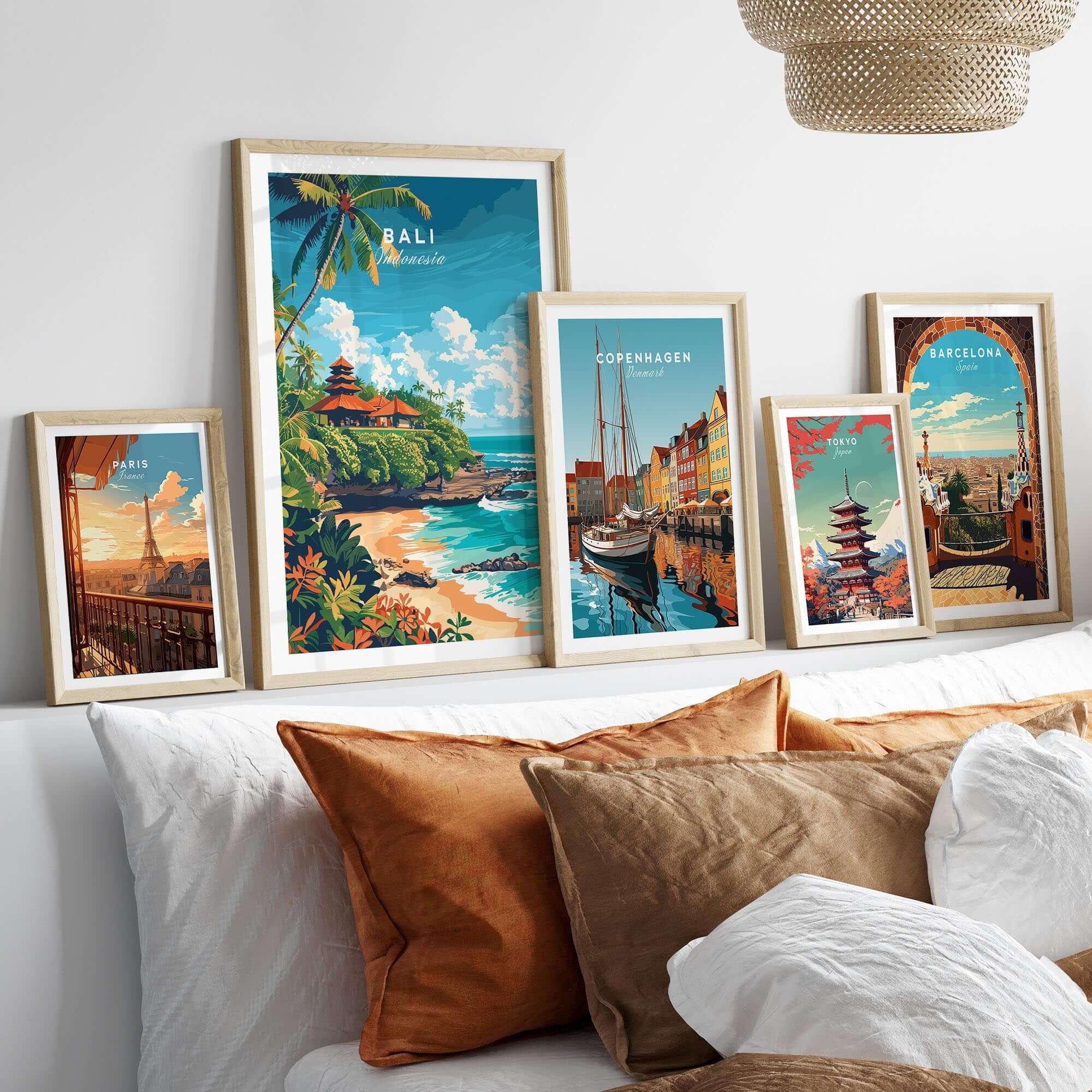Bali Beach Print and other travel posters displayed on a stylish bed with decorative pillows.