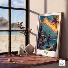 Bali Sunset Wall Art Print displayed on a wooden table next to a window, showcasing a serene beach view.