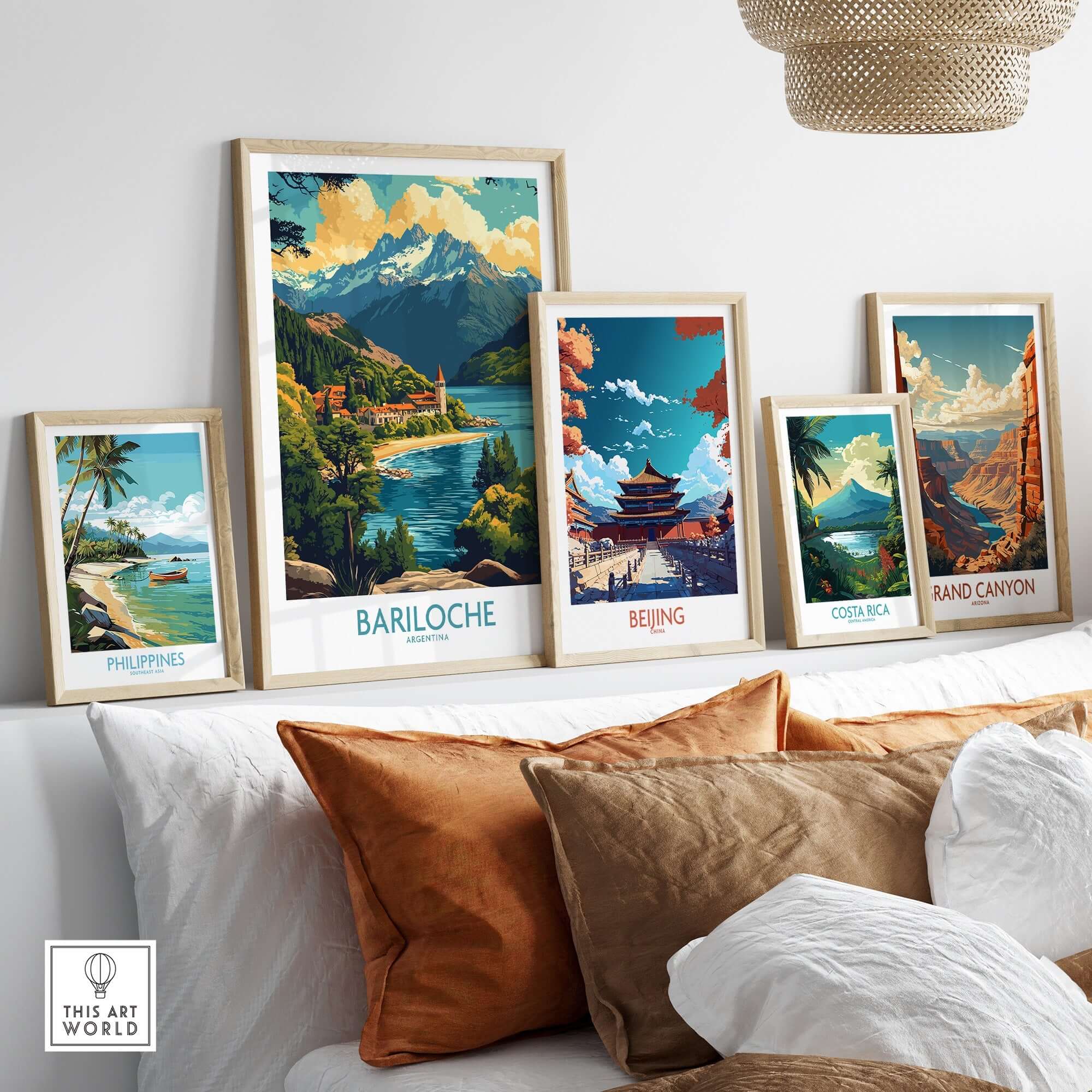 Bariloche Travel Poster displayed among other travel posters on a stylish couch in a modern living room.
