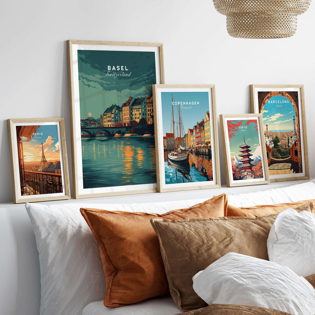 Framed cityscape prints of Basel, Copenhagen, and Barcelona displayed on a cozy sofa, enhancing home decor.