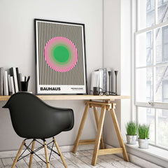 Bauhaus Exhibition Prints - Concentric Circles Poster Pink Green Striped Art displayed in a modern study with a stylish chair.