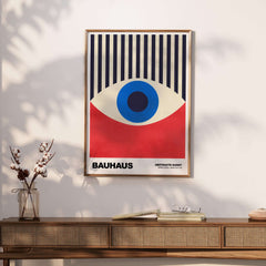Bauhaus Exhibition Prints - Abstract Eye Art Print Geometric Red Blue Design displayed on a wall with a stylish wooden table.