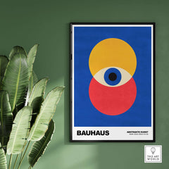 Bauhaus Exhibition Prints - Abstract Eye Circles Poster - Blue Yellow Red Primary Art displayed on a green wall.