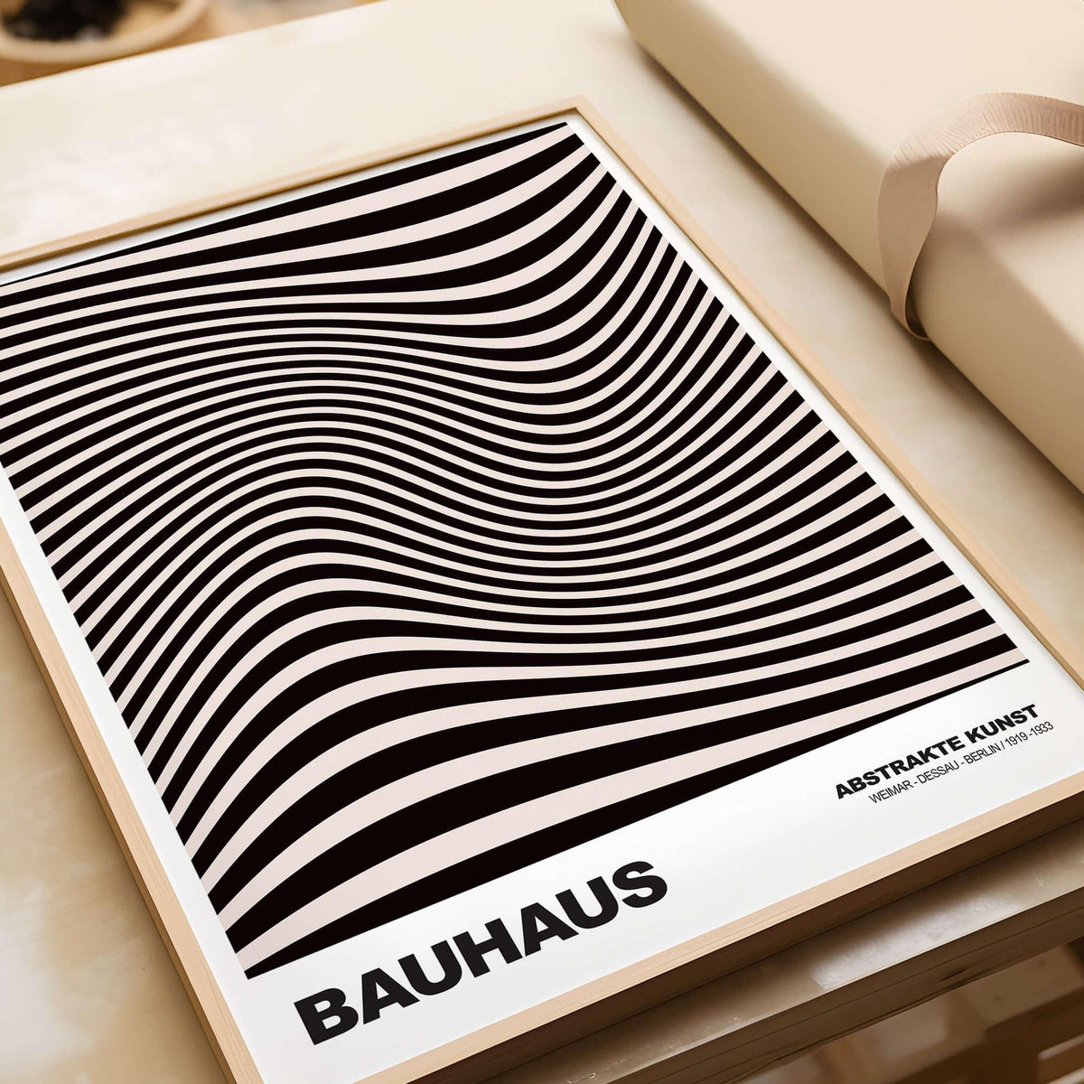 Bauhaus Exhibition Prints -  Optical Wave Lines Art Print Black Cream Abstract displayed on a wooden surface.