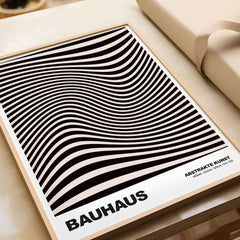 Bauhaus Exhibition Prints -  Optical Wave Lines Art Print Black Cream Abstract displayed on a wooden surface.