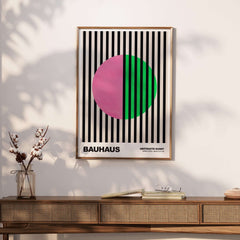 Bauhaus Exhibition Prints - Split Circle Abstract Art Print Pink Green Stripes displayed on a wall.