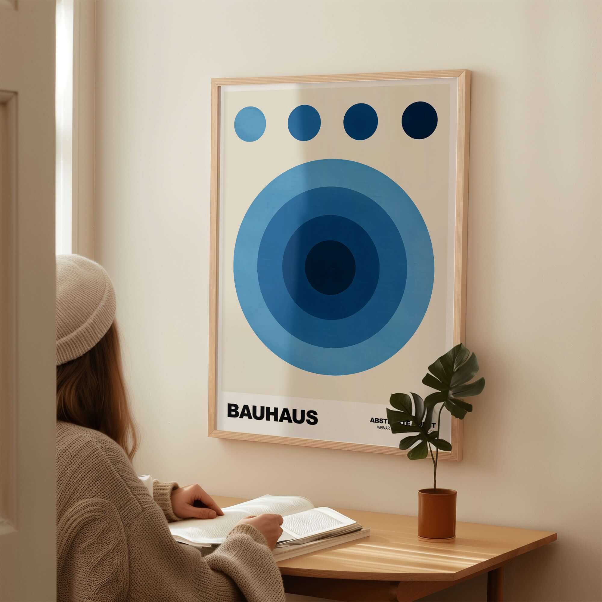 Bauhaus Exhibition Prints - Abstract Blue Circles Poster Geometric Design displayed on a wall with a person studying.