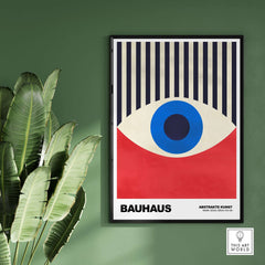 Bauhaus Exhibition Prints - Abstract Eye Art Print Geometric Red Blue Design on green wall with plant.