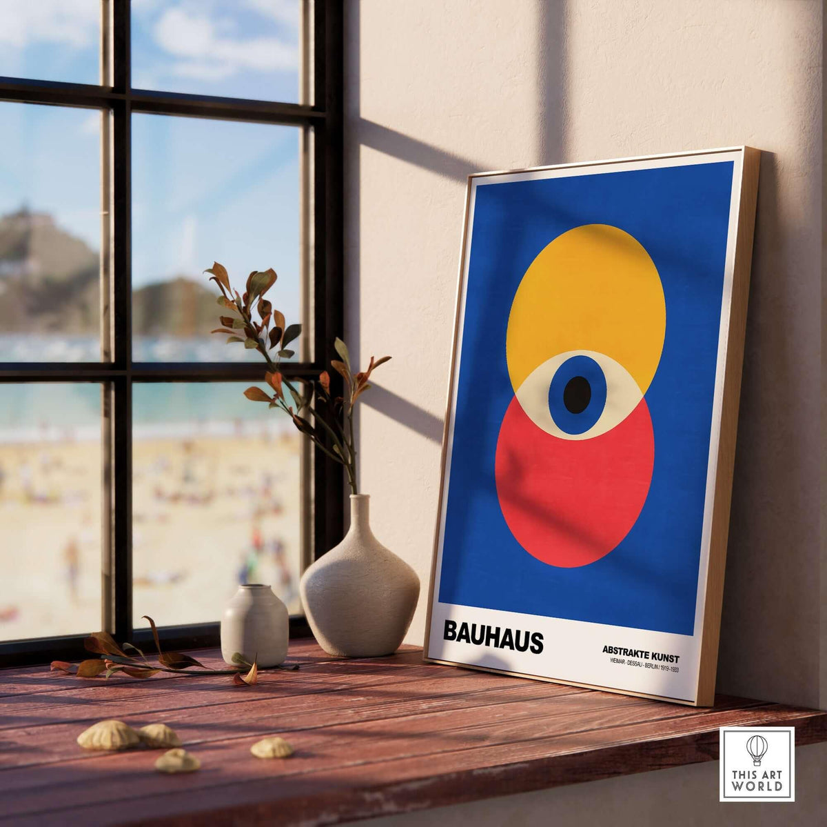 Bauhaus Exhibition Prints - Abstract Eye Circles Poster - Blue Yellow Red Primary Art displayed by a window with beach view.