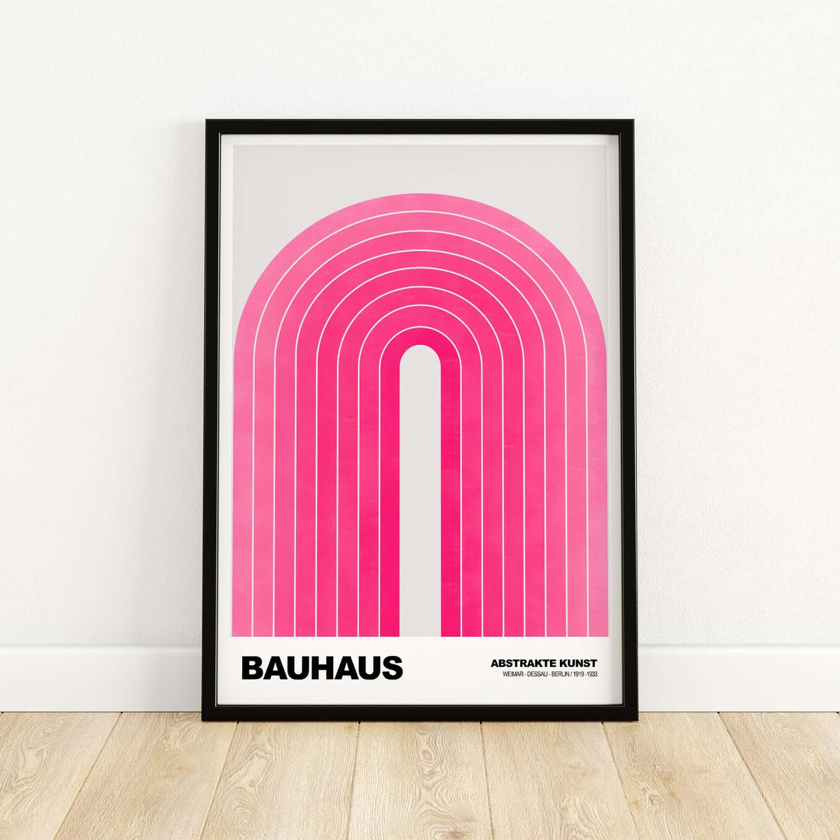 Bauhaus Exhibition Prints - Concentric Pink Arch Poster Minimalist Geometric Art framed on wall with wooden floor.