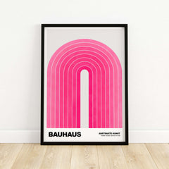 Bauhaus Exhibition Prints - Concentric Pink Arch Poster Minimalist Geometric Art framed on wall with wooden floor.
