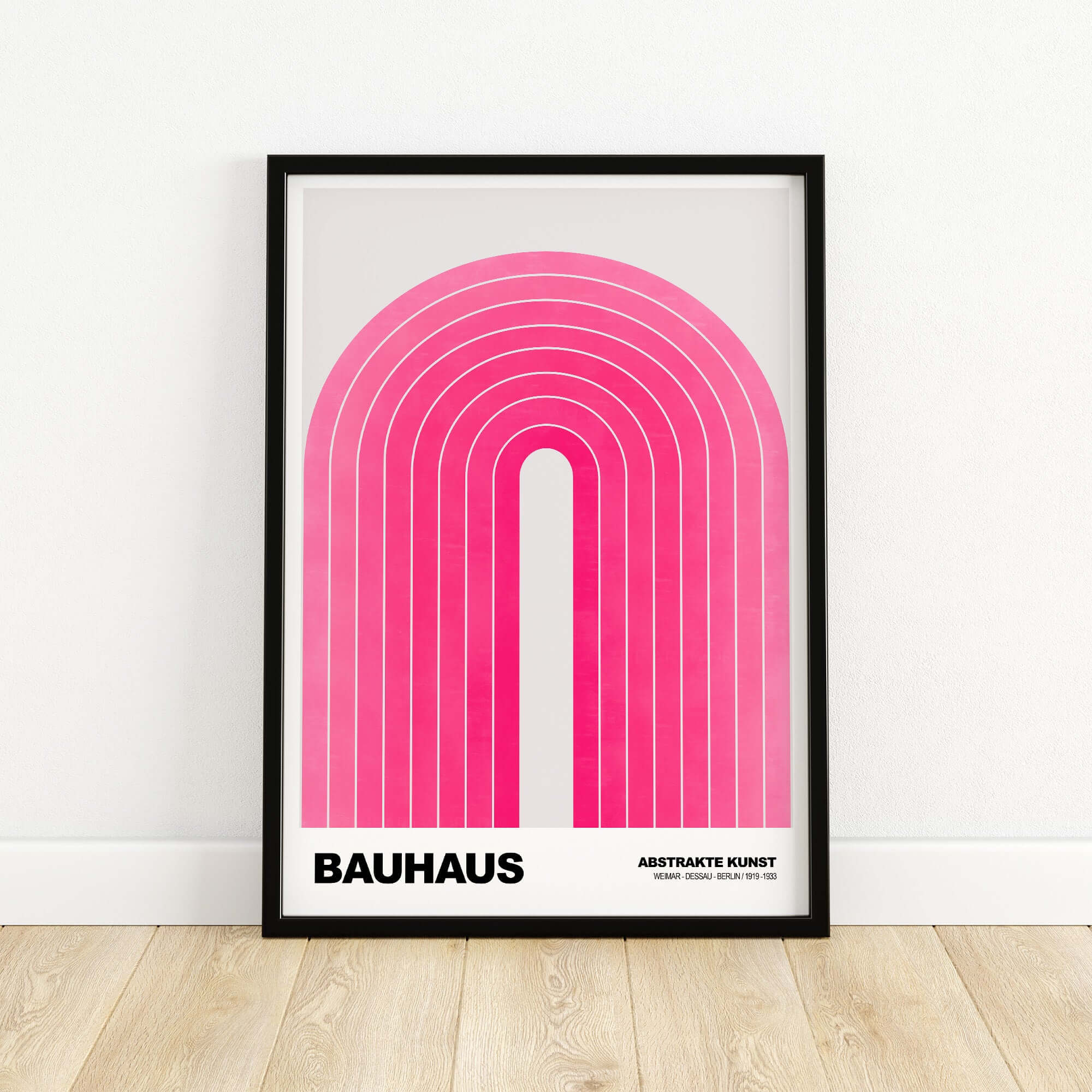 Bauhaus Exhibition Prints - Concentric Pink Arch Poster Minimalist Geometric Art framed on wall with wooden floor.