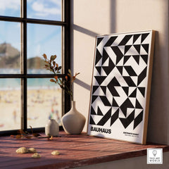 Bauhaus Exhibition Prints - Geometric Triangle Pattern Poster Black White Abstract displayed in a bright room by the window.