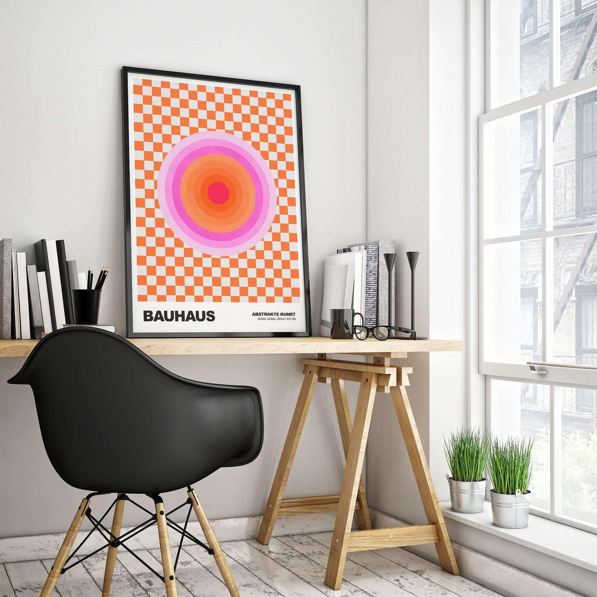 Bauhaus Exhibition Prints - Pink Circles Poster Orange Checkerboard Art displayed in a modern workspace with black chair.