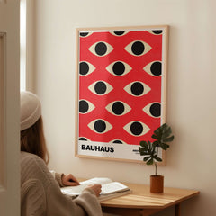Bauhaus Exhibition Prints - Repeating Eyes Pattern Poster Red Black Cream Art displayed on a wall in a stylish interior.