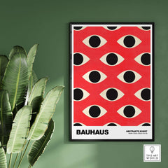 Bauhaus Exhibition Prints - Repeating Eyes Pattern Poster Red Black Cream Art displayed in a modern setting with tropical plants.