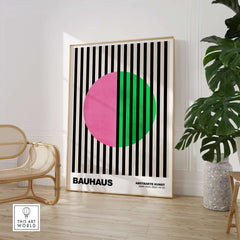 Bauhaus Exhibition Prints - Split Circle Abstract Art Print Pink Green Stripes displayed in a stylish modern interior.