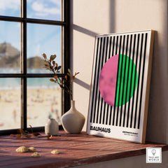 Bauhaus Exhibition Prints - Split Circle Abstract Art Print Pink Green Stripes displayed in a bright interior setting.