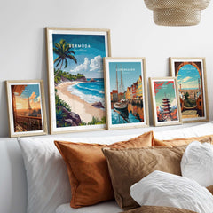 Bermuda Print featuring a tropical beach scene among framed travel posters on a stylish sofa.