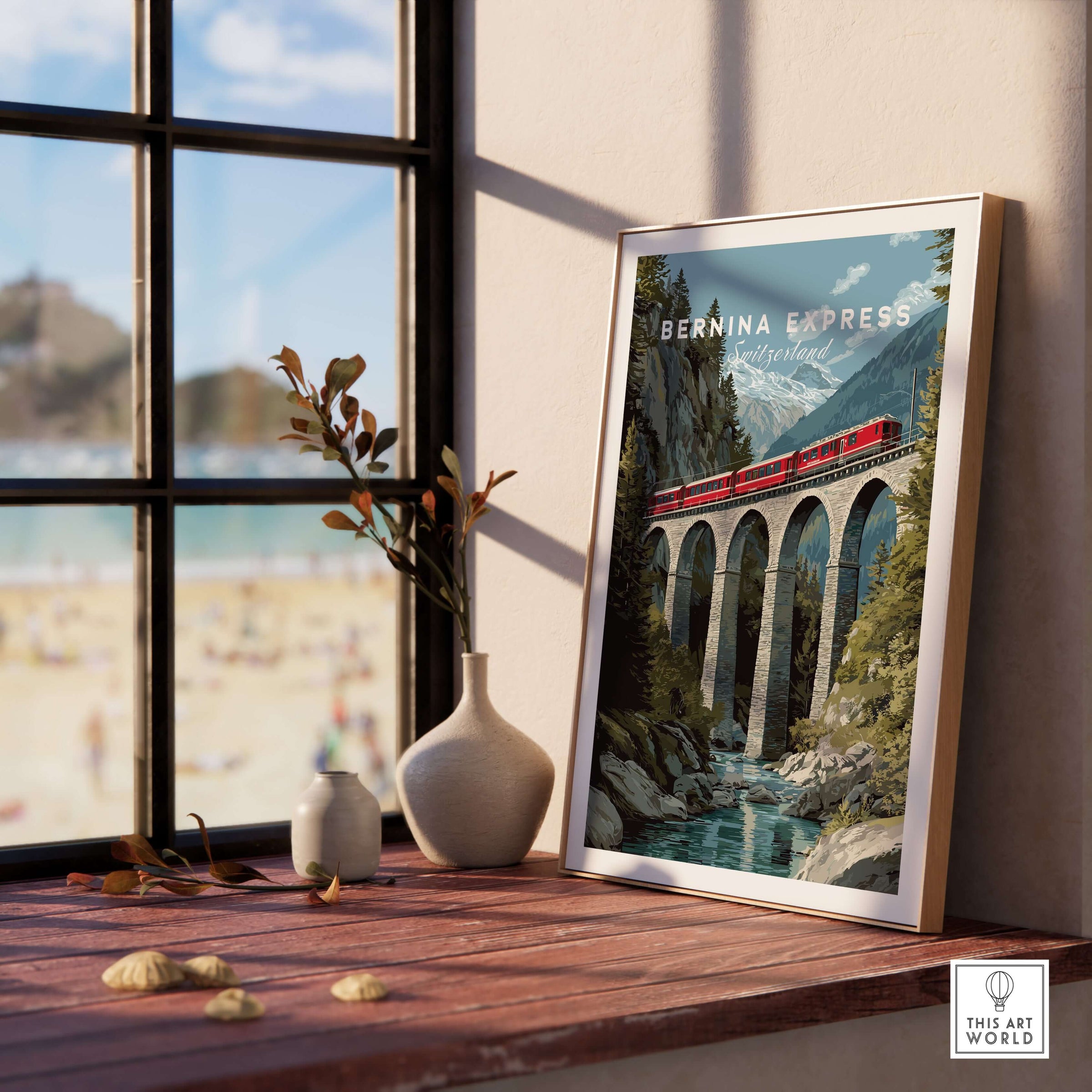 Bernina Express Print | Swiss Alps Travel Decor shown framed on a table by a window with a beach view.