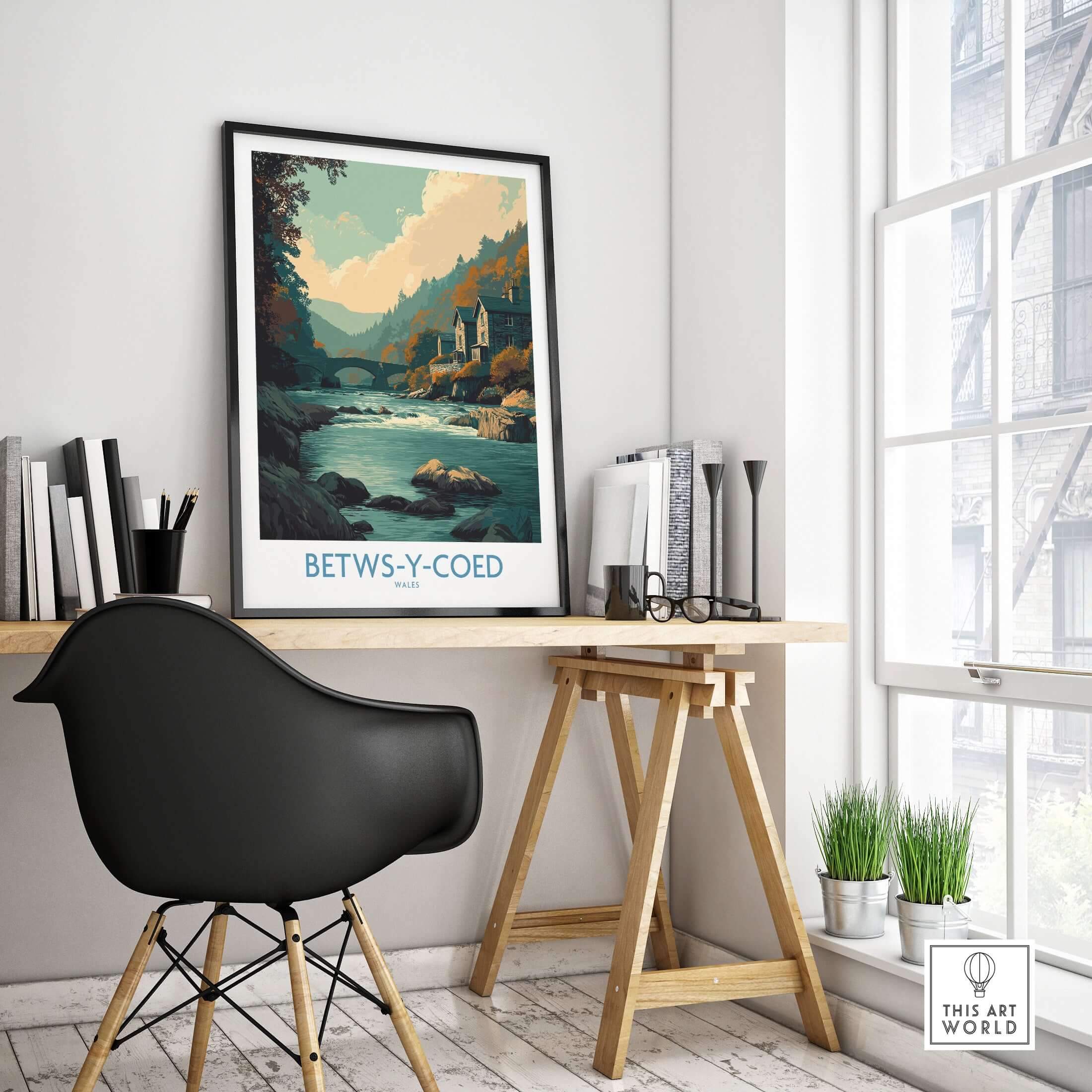 Betws-y-Coed Poster Wales Art Print displayed on a desk in a stylish home office setting.